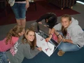8th grade class signing plastic cookits in route to Sudan.jpg