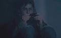 Harry Potter examining a shard of the Two-way Mirror given by Sirius Black.jpg