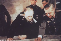 Walther Wenck points at a map and Heinz Guderian looks