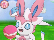 Sylveon comiendo un pastel en el Poké Recreo XY