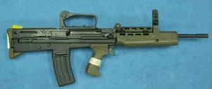 A L98 lying of its left side with the cocking handle showing.