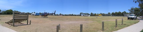 A temporary helicopter landing pad set up on Rofe Park during the bushfire in the Ku-ring-gai Chase National Park in January 2007. Helicopters and refueling tanks are visible in this photograph by John Dalton.