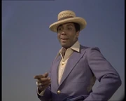 Herb Jefferson, Jr. as Baxley/Beaumont introduces himself to Jaime on the beach