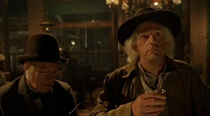 The barbwire salesman talks to Emmett.