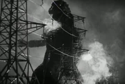 Godzilla is temporarily halted by an electric fence.