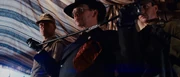 Toht prepares to hang his coat.