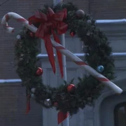 A Christmas wreath hangs in 20th century Earth