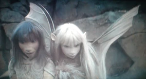 Kira, pictured with her wings open carrying Jen and Fizzgig.