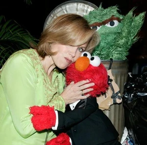 Couric with Elmo at a Sesame Workshop event.