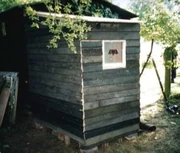 The same compost toilet viewed from outside. This structure was built entirely from recycled materials[2]