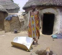 In Ghana, Zouzugu villagers, like this woman, prevent dracunculiasis and other waterborne diseases by pasteurizing water in CooKits.