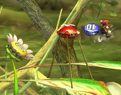 Mario throwing a Blue 10 pellet into a Red Onion. A Yellow 10 pellet Posy is also in view.