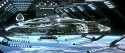 Enterprise in drydock over Earth.