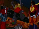 Perceptor and Rodimus watch as Grimlock does a jaunty jig on the enemies' heads.