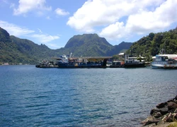 Portion of the dock area at Fagatogo, Pago Pago Harbor, American Samoa with Rainmaker Mt. (Pioa Mtn.) in the background.