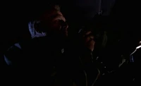 Detective Miles driving a patrol car in 2000, moments before a disastrous incident.