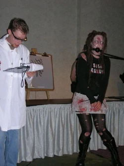 A ZS "zombologist" lectures the Archon crowd about his captive undead subject.